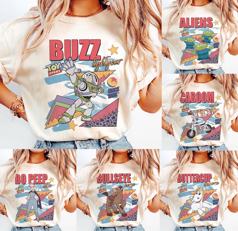 May include: Cream-colored t-shirts featuring various Toy Story characters and phrases. Designs include "Buzz Lightyear," "Aliens," "Caboom," "Bo Peep," "Bullseye," and "Buttercup," with retro-style graphics and the Toy Story logo.