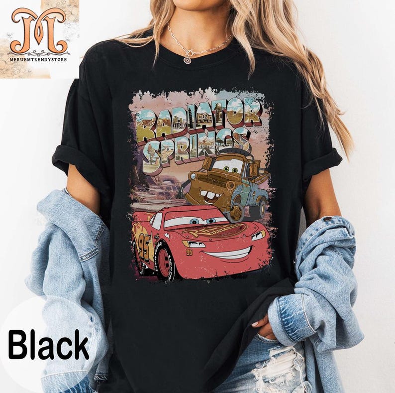 May include: Black t-shirt with a graphic of Lightning McQueen and Mater from Cars. The graphic includes the text "Radiator Springs".