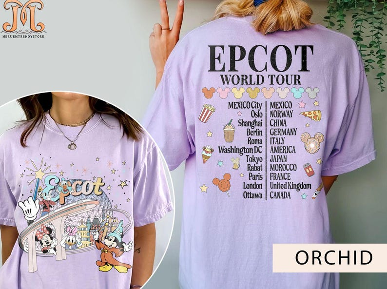 May include: A purple t-shirt featuring a graphic of Mickey Mouse and friends at Epcot. The shirt also displays the text "Epcot World Tour" and a list of cities from around the world.