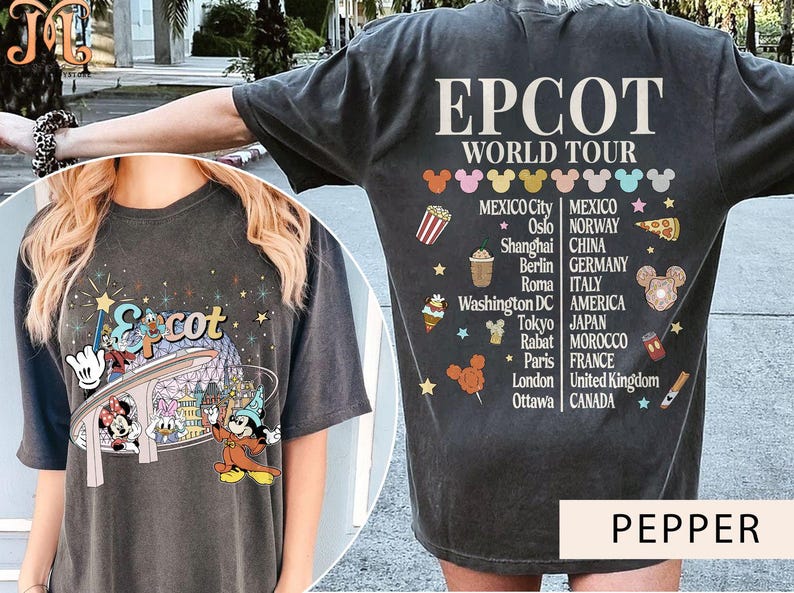 May include: A black t-shirt featuring a graphic of Mickey Mouse and friends at Epcot's World Showcase. The shirt also includes the text "Epcot World Tour" and a list of countries represented at the World Showcase.