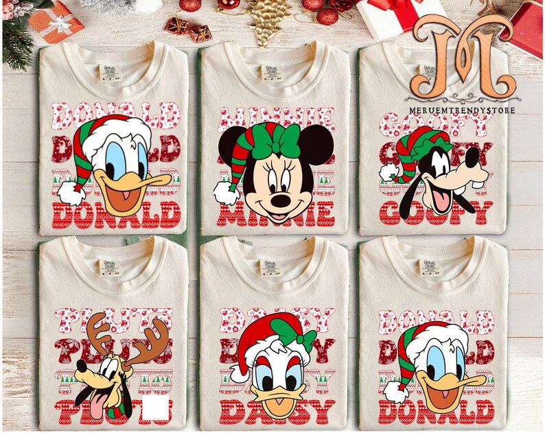 May include: Six cream-colored t-shirts featuring Disney characters in Christmas attire. Donald Duck, Minnie Mouse, Goofy, Pluto, Daisy Duck, and Donald Duck are depicted with festive hats and names in red block letters.
