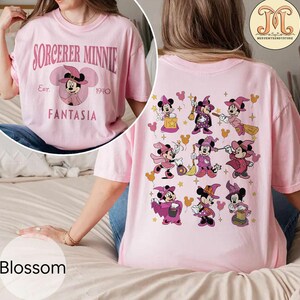 May include: Pink t-shirt with the text "SORCERER MINNIE Est. 1940 FANTASIA" on the front and a design of nine Minnie Mouse characters dressed as witches on the back.