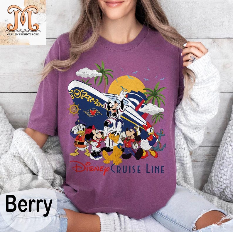 May include: Berry-colored t-shirt featuring a Disney Cruise Line graphic. The design includes Mickey Mouse, Minnie Mouse, Donald Duck, and Goofy, along with a cruise ship, palm trees, and a sunset. The text "Disney Cruise Line" is printed below the characters.