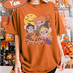 May include: Orange Comfort Colors t-shirt with a Halloween-themed graphic. The graphic features cartoon characters, pumpkins, a full moon, bats, and a spooky tree. The shirt has the word "Yam" in a brown oval.