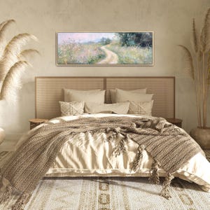 a bedroom with a large bed and a painting on the wall