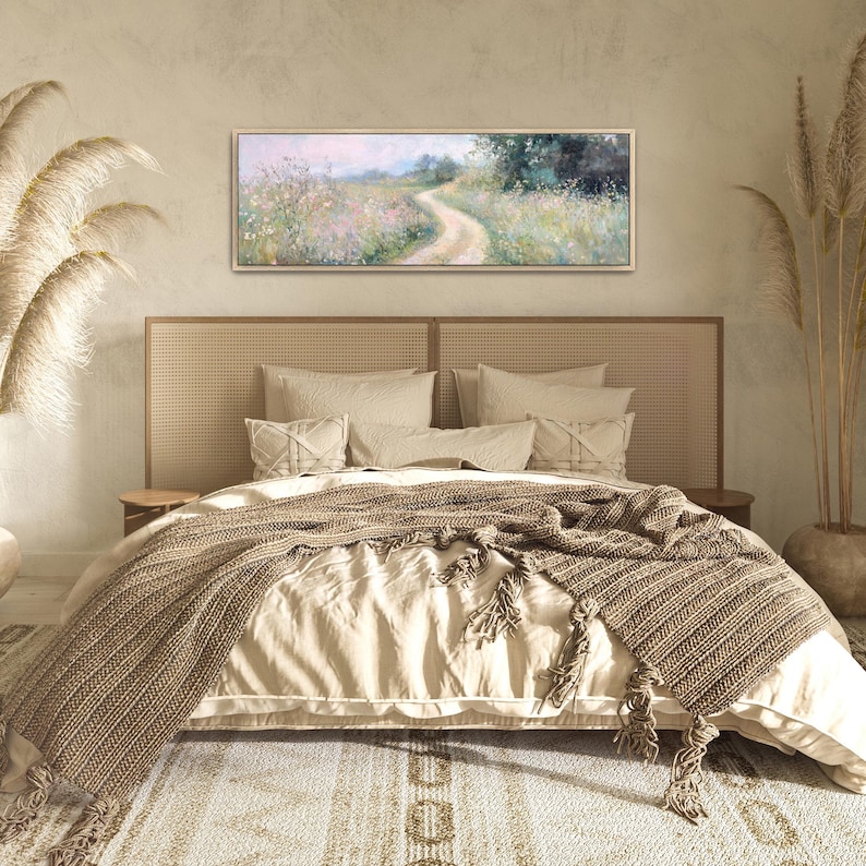 a bedroom with a large bed and a painting on the wall
