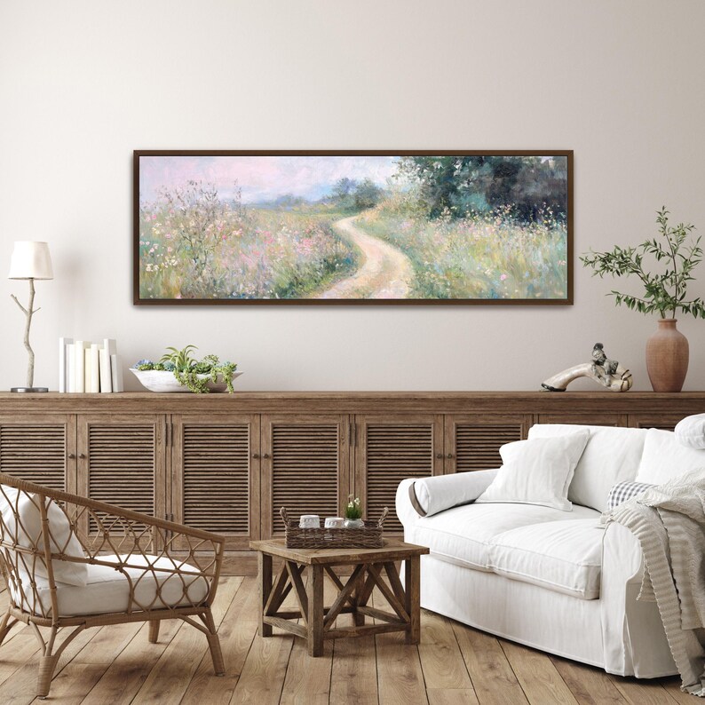 May include: A long, horizontal painting of a winding path through a field of wildflowers. The path leads to a small, wooded area in the distance. The painting is done in a soft, impressionistic style with muted colors.