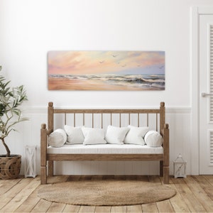 a white couch sitting in a living room under a painting