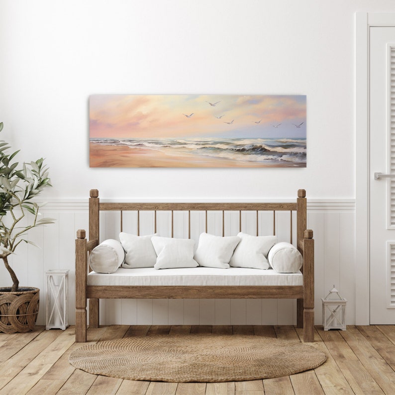 a white couch sitting in a living room under a painting