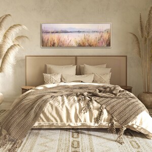a bedroom with a large bed and a painting on the wall