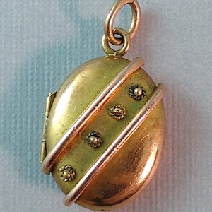 Etruscan revival rolled gold oval locket