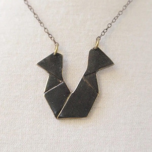 Origami Necklace No. 2 by Coma Barcelona. Unique Delicate Handcrafted Jewelry with a Original and Modern Design. Golden Brass Black Patina.