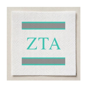 May include: A square white needlepoint canvas featuring the letters ZTA in a bold turquoise serif font centered between two horizontal grey stripes, each bordered by thin turquoise lines, creating a clean and symmetrical geometric design.