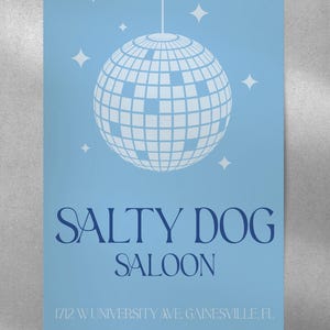May include: A blue poster with a white disco ball and the text "Salty Dog Saloon" in navy blue. The address "1712 W University Ave. Gainesville, FL" is printed in navy blue at the bottom.