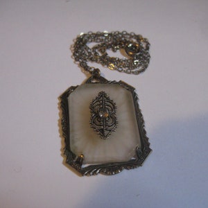 Art Deco Camphor Glass Rectangulsr Pendant Necklace with Filigree Center Attachment that has a Rhinestone