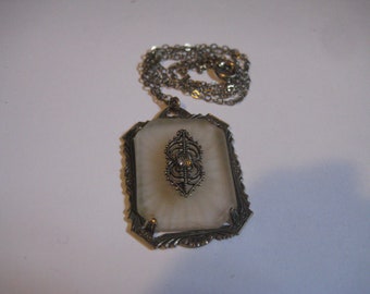Art Deco Camphor Glass Rectangulsr Pendant Necklace with Filigree Center Attachment that has a Rhinestone