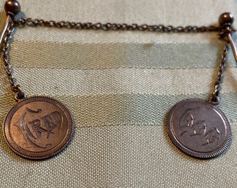 Double Cloak or Cape Stickpin with Coin Shaped Dangles FRED and EMMA on Front Initials on Back