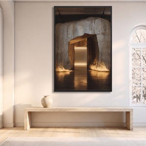 May include: A framed vertical wall art print featuring a dark, cavernous stone entrance with warm, glowing interior lighting. The scene depicts a textured rock formation surrounding a rectangular opening, creating a high-contrast visual effect.
