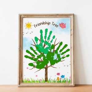 May include: A framed print of a green handprint tree with the words "Friendship Tree" at the top. The tree is surrounded by a blue sky with white clouds, a yellow sun, and pink flowers. There are also three small birds, one pink, one yellow, and one blue.