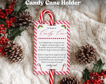 May include: A candy cane holder with a red and white striped design. The holder features the text "The Wonder of Candy Cane" and a poem. The image includes a candy cane, holly, and pinecones, evoking a festive Christmas theme.