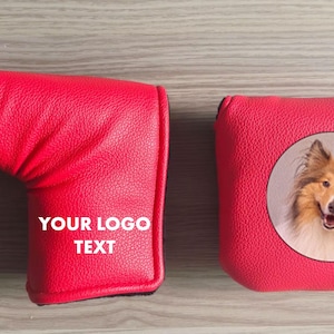 May include: Two red golf club head covers. One is a putter cover with the text "YOUR LOGO TEXT". The other is a square cover with a dog's face in a circle.