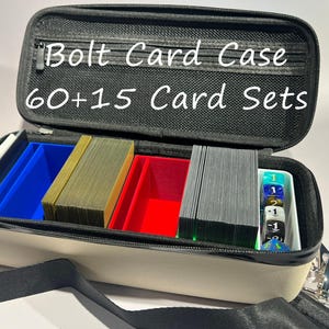 May include: Open Bolt Card Case with the text "Bolt Card Case 60+15 Card Sets." The beige case has a black zipper and a black shoulder strap. Inside are blue, red, and green card holders filled with card sets and dice.