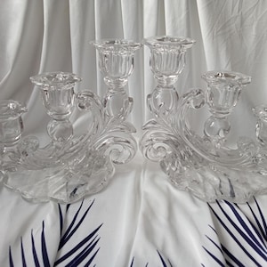 A set of Vintage Collectible Antique Glass Three Arm Candle Stick Holders made by Cambridge Glass in the Caprice Pattern with an Etched Base