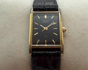 Ricoh Damen-Quarzuhr – 1987 | Schwarzes Zifferblatt | schlankes goldfarbenes Gehäuse | Japanische Vintage Armbanduhr