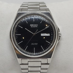 Seiko SQ 100 Quartz Watch – Black Dial, Vintage 1989, Original Strap, Very Good Condition
