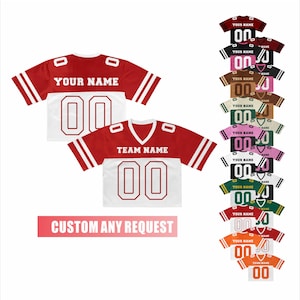May include: Red and white football jerseys with the text "YOUR NAME" and "TEAM NAME" above the number "00". A variety of jersey color combinations are displayed, along with the text "CUSTOM ANY REQUEST".