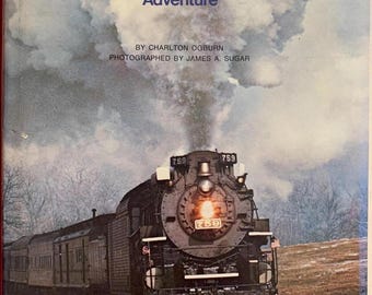 May include: A hardcover book titled RAILROADS The Great American Adventure by Charlton Ogburn, photographed by James A. Sugar. The cover features a black steam locomotive numbered 759 emitting thick smoke, published by National Geographic Society.