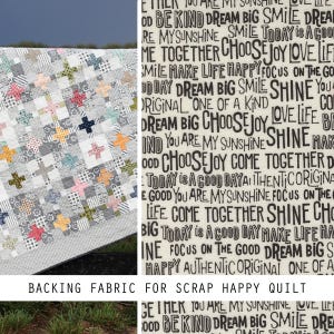 May include: A quilt featuring a patchwork pattern of small multicolored plus signs on a white background, paired with a backing fabric printed with black text including phrases like Dream Big, Smile, Shine, and Choose Joy on a cream background.