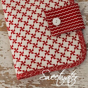 May include: Red and white sewing organizer with a red and white zig-zag pocket and a white button. The organizer is labeled "mama's stuff sewing organizer #P194" and "mama said sew collection".