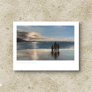 May include: A painting depicting a family of three walking on a beach at sunset. The artwork shows a blue and grey sky, with the sea reflecting the light. The print is labelled "constantine bay".