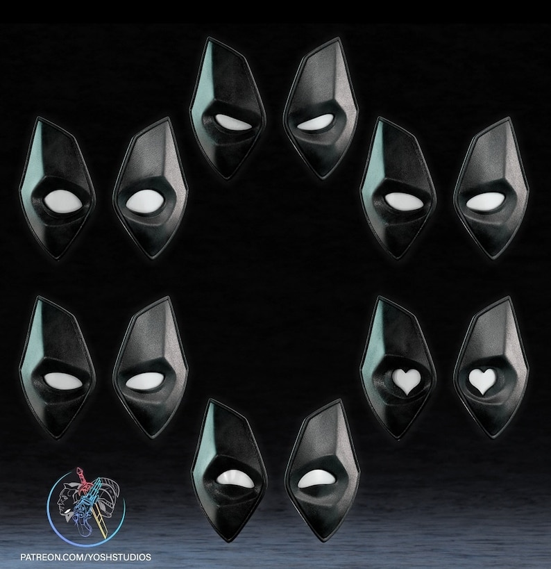 May include: A set of 10 black diamond-shaped masks with different white eye designs. The masks have a glossy finish and are arranged in a circle.