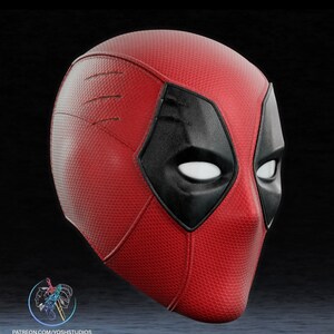 May include: A red and black Deadpool mask with a textured surface. The mask has a black eye mask with white eyes.