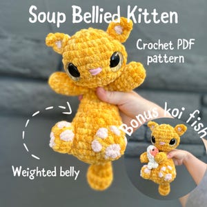 May include: A crocheted orange kitten with a weighted belly and pink paw pads. The kitten is being held by a hand. The image also shows a crocheted koi fish. The text "Soup Bellied Kitten Crochet PDF pattern Bonus koi fish" is visible in the image.