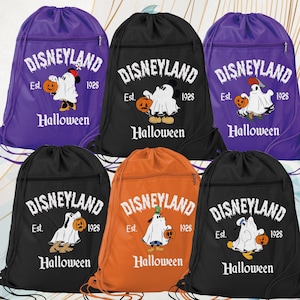 May include: Drawstring backpacks in purple, black, and orange feature a Halloween-themed Disneyland design. Each bag displays the Disneyland logo, the year 1928, and a cartoon character dressed as a ghost holding a pumpkin. The word "Halloween" is printed below.