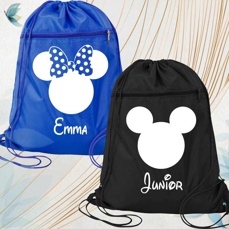 May include: Two drawstring bags. One is blue with a white Minnie Mouse design and the name "Emma". The other is black with a white Mickey Mouse design and the name "Junior". Both have a zipped pocket.