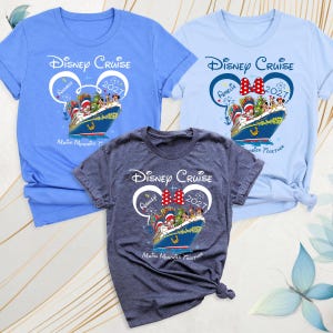 May include: Three short-sleeve t-shirts in blue, light blue, and heather gray. Each features a graphic of a cruise ship with Disney characters, a Mickey Mouse ear outline, the text Disney Cruise, 2027, and personalized names.