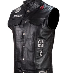 May include: Black leather motorcycle vest with multiple patches, including "Biker", "Road Captain", "F.T.W.", a cross, and "M.F."