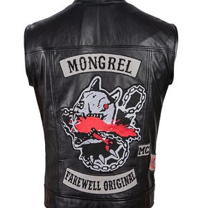 May include: Black leather vest with a large embroidered patch featuring a snarling dog with a chain and the text "MONGREL" above it. The vest also has a smaller patch with the text "FAREWELL ORIGINAL" and "MC" below it.