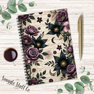 May include: Spiral-bound notebook with a floral design featuring dark purple roses and black flowers. The notebook has a cream-colored background with script writing and a gold pen. A cup of coffee and the text "Snuggle Stuff Co." are also visible.
