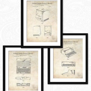 May include: Three vintage black framed prints of Apple computer patents. The top print shows a drawing of the Apple Macintosh 128K computer. The middle print shows a drawing of the Apple IIe computer. The bottom print shows a drawing of the Apple Lisa computer.