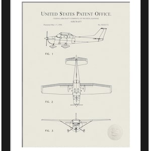 May include: Black framed print of a Cessna aircraft patent. The print shows three views of the aircraft: side, top, and front. Text includes "United States Patent Office" and "Cessna Aircraft Company, of Wichita, Kansas."
