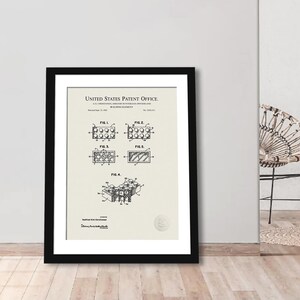 May include: A black and white patent drawing for a building element, also known as a brick, with the text "United States Patent Office" at the top. The drawing shows four different views of the brick, labeled "Fig. 1", "Fig. 2", "Fig. 3", and "Fig. 4".