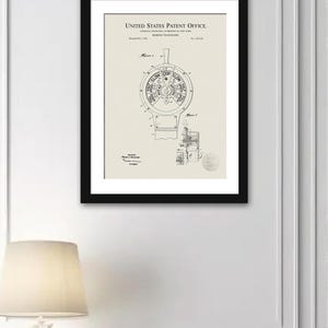 May include: A framed patent print of a marine telegraph, showing a circular dial with speed settings such as "SLOW" and "FULL SPEED." The black and white illustration is set against a cream backdrop, within a black frame.
