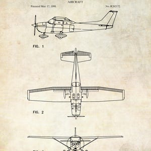 May include: A vintage patent illustration of an aircraft, featuring three views: side, top, and front. The text reads "United States Patent Office" and "Cessna Aircraft Company, of Wichita, Kansas." The patent date is March 17, 1998. The design is in black ink on a beige background.