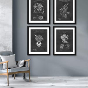 May include: Four black framed prints with white text and illustrations of vintage patent drawings for a telescope. The text on each print reads "United States Patent Office".
