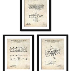 May include: Three framed patent prints of a flying machine, each in a black frame. The prints are on aged paper and feature detailed technical drawings and text from the United States Patent Office. The drawings depict the Wright brothers' invention.